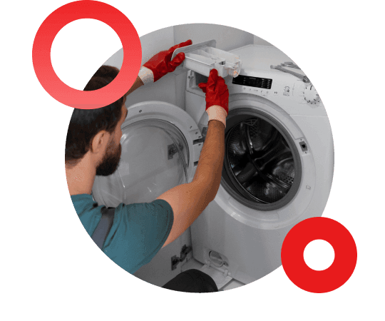Technician repairing a front-load washing machine in a home